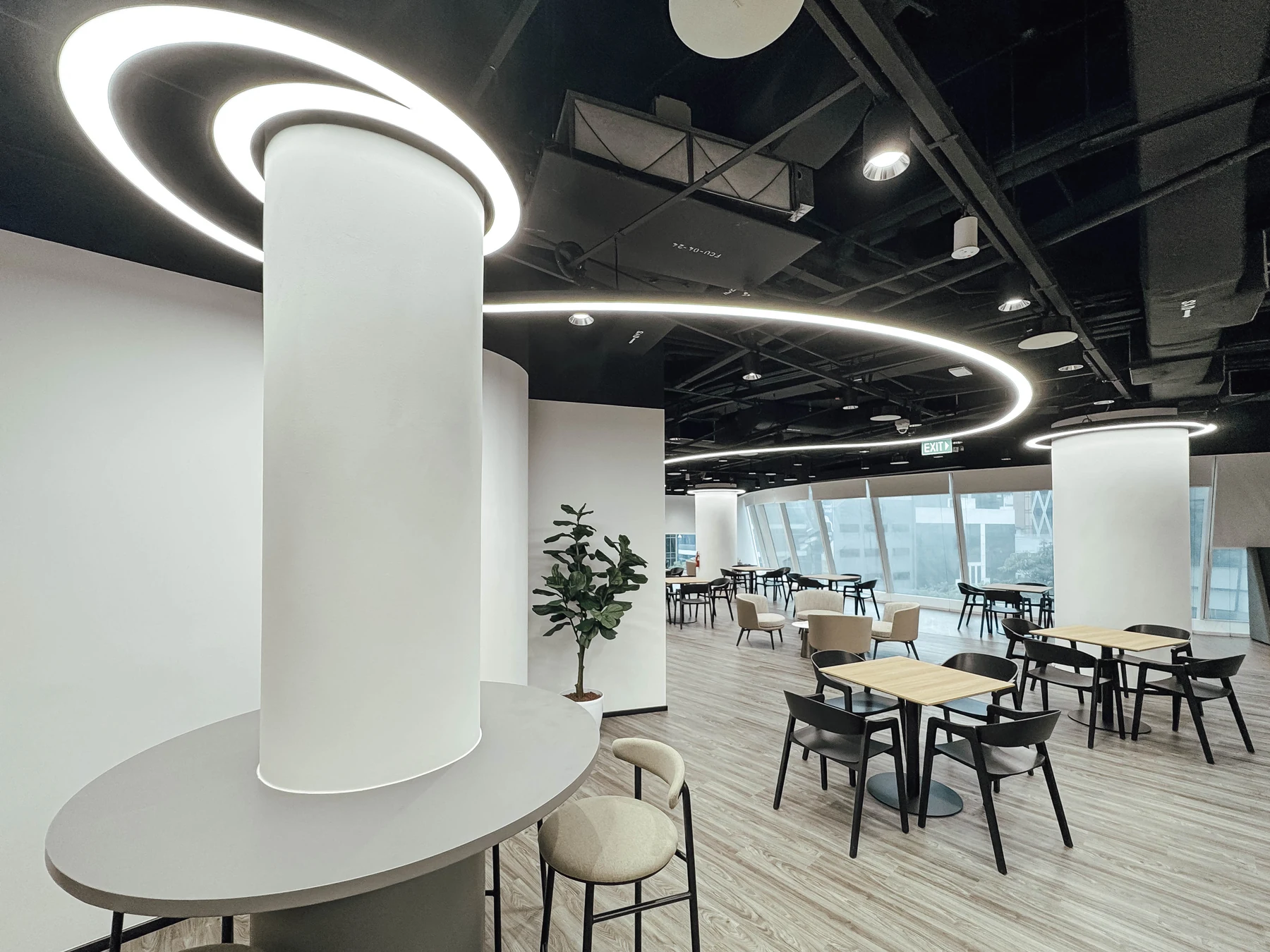 Custom circular architectural lighting feature in an open workplace