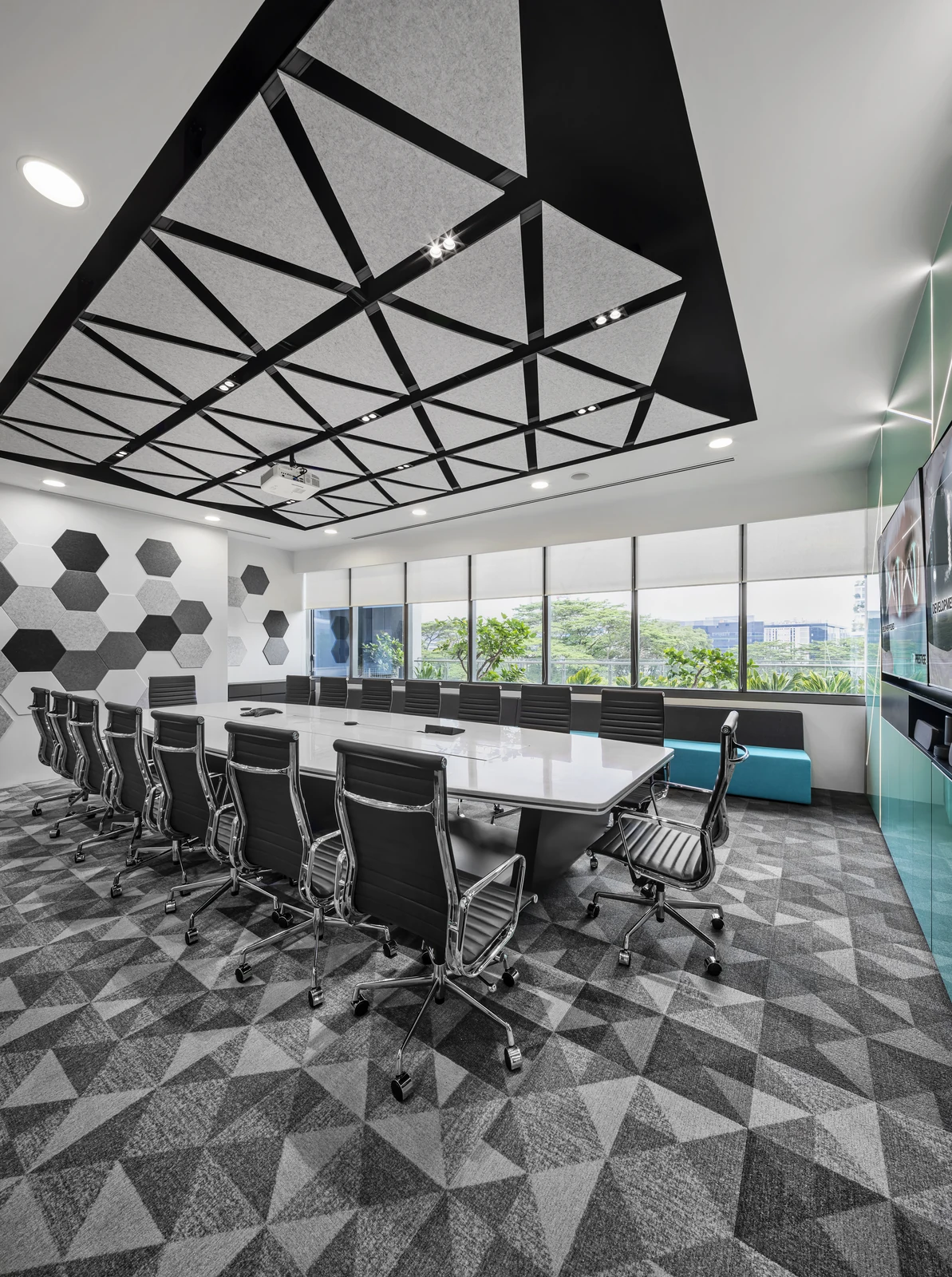 Custom acoustic meeting room with geometric ceiling and wall treatment